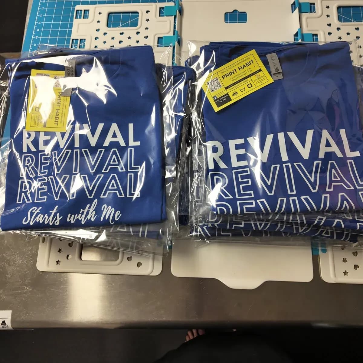 Custom DTF-printed t-shirts folded and bagged, ready for pickup at Print Habit in Coatesville, PA