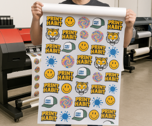 a man holding a large dtf transfer gang sheet roll with different designs
